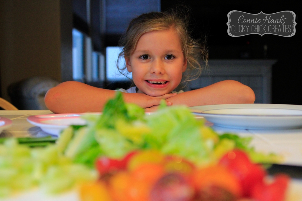 Connie Hanks // ClickyChickCreates.com // what's for dinner, mom? daughter snacking during dinner prep