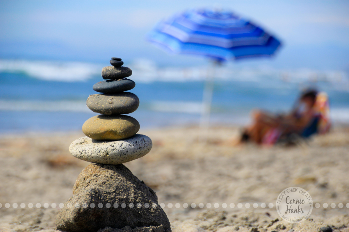 Connie Hanks Photography // ClickyChickCreates.com // San Diego beach, balance, rocks, beach pebbles, umbrella, waves, sand, relaxing