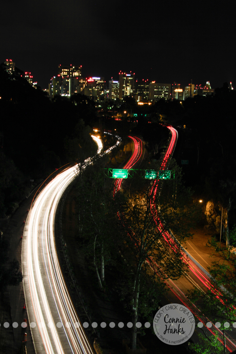Connie Hanks Photography // ClickyChickCreates.com // Long exposure shot from bridge in Balboa Park over 163 with San Diego skyline in the background