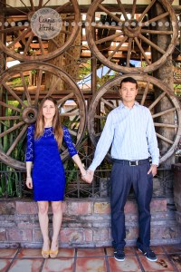 Connie Hanks Photography // ClickyChickCreates.com // engagement couple session, Rosarito, Mexico, mercado, market, colorful, blue, gray, wood, wheel, rustic, arches, archways, kiss