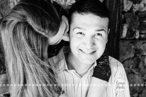 Connie Hanks Photography // ClickyChickCreates.com // engagement couple session, Rosarito, Mexico, mercado, market, colorful, blue, gray, wood, wheel, rustic, arches, archways, kiss, B&W